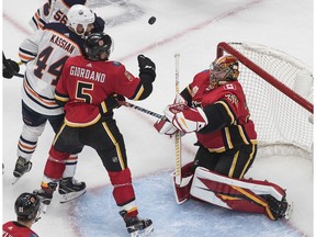 The Calgary Flames' Mark Giordano and Edmonton Oilers' Zack Kassian battle for the rebound as Flames goalie David Rittich makes the save during an NHL exhibition game at Rogers Place in Edmonton on Tuesday, July 28, 2020. Jason Franson/The Canadian Press ORG XMIT: EDM137