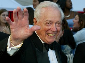 Hugh Downs, former host of the ABC news program "20/20" poses as he arrives for the ABC television network's 50th anniversary in Hollywood March 16, 2003.