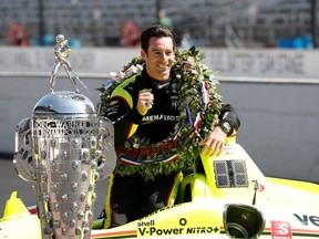 Simon Pagenaud poses with his car and the Borg Warner Trophy during a photo shoot after the 103rd Running of the Indianapolis 500 at Indianapolis Motor Speedway.