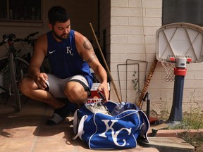 MLB pitcher Jakob Junis with the Royals puts equipment back into a bag after a backyard throwing session in Scottsdale, Ariz., June 5, 2020.