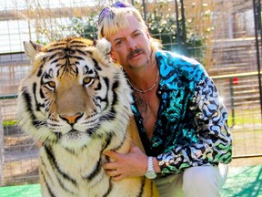 This undated file photo courtesy of Netflix shows Joseph "Joe Exotic" Maldonado-Passage with one of his tigers.