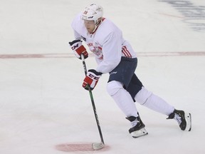 Washington Capitals centre Lars Eller skates with the puck during a workout at MedStar Capitals Iceplex.