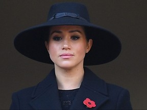 In this file photo taken on November 10, 2019 Britain's Meghan, Duchess of Sussex, looks on from a balcony as she attends the Remembrance Sunday ceremony at the Cenotaph on Whitehall in central London.