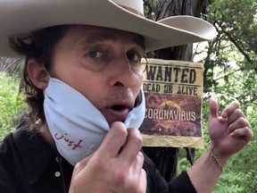 Actor Matthew McConaughey appears as "Bobby Bandito," teaching people how to make a mask, during the coronavirus outbreak, in this still image obtained from a social media video, uploaded April 13, 2020.
