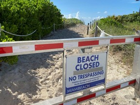 A sign informing about the closure of South Beach, to prevent the spread of COVID-19, is seen ahead of the Fourth of July weekend, in Miami, Friday, July 3, 2020.