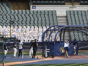 The Milwaukee Brewers take batting practice after a game against the St. Louis Cardinals was cancelled due to the pandemic July 31, 2020 at Miller Park.
