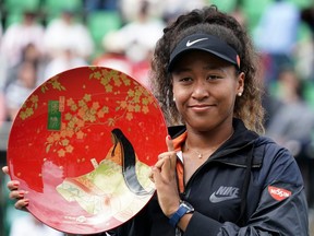 Singles champion Naomi Osaka of Japan poses for photographs with the trophy after the final against Anastasia Pavlyuchenkova of Russia at the Toray Pan Pacific Open at Utsubo Tennis Centre in Osaka, Japan, Sept. 22, 2019.