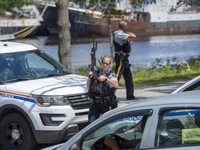 RCMP officers maintain a roadblock as they search for a suspect after a Bridgewater Police Service officer was stabbed as he responded to a domestic violence complaint at The Bridgewater Hotel in Bridgewater, N.S. on Tuesday, July 21, 2020.
