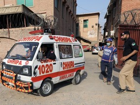 An ambulance carrying the body of a man, who according to police was killed by a gunman during a proceeding at a judicial complex, moves out of the Khyber Medical College morgue, in Peshawar, Pakistan July 29, 2020.