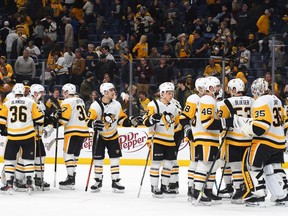 Pittsburgh Penguins goaltender Tristan Jarry (35) is congratulated by teammates after a win against the Nashville Predators at Bridgestone Arena.