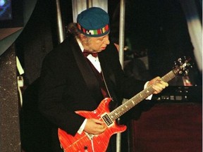 Rarely seen guitarist Peter Green, of the original Fleetwood Mac band, performs his original song "Black Magic Woman" with Carlos Santana (not seen) following Santana's induction into the Rock and Roll Hall of Fame at the Rock and Roll Hall of Fame Foundation's Thirteenth Annual Induction Dinner at New York's Waldorf Astoria Hotel, U.S., January 12, 1998.