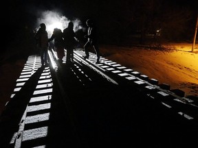 Migrants from Somalia cross into Canada illegally from the United States by walking down a train track into the town of Emerson, Man., on Feb.26, 2017.