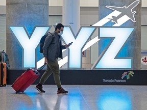 A passenger walks through Pearson airport.