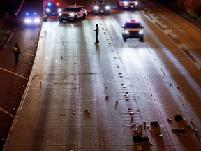 Washington State Troopers investigate the scene where two people in a group of protesters were struck by a car on Interstate 5 while the highway was closed to traffic due to the protest in Seattle, Saturday, July 4, 2020.
