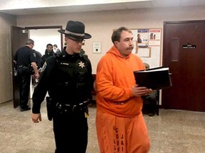 In this Tuesday, Jan. 22, 2019 photo, a law enforcement officer leads William Shrubsall through the Niagara County Court House in Lockport, N.Y.