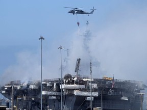 A U.S. Navy helicopter continues fighting a fire on the amphibious assault ship USS Bonhomme Richard at Naval Base San Diego, in San Diego July 13, 2020.