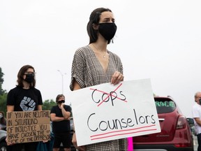 People protest in support of a Groves High School Black fellow student, who was jailed due to a probation violation of not keeping up with her online schoolwork, in front of the Oakland County Circuit Court and Prosecutors Office in the Detroit suburb of Pontiac, Michigan, July 16, 2020.