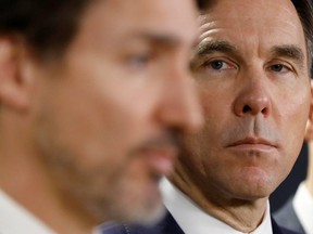 Canada's Minister of Finance Bill Morneau looks at Prime Minister Justin Trudeau during a press conference in Ottawa, Ontario, Canada March 11, 2020.