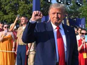 U.S. President Donald Trump pumps his fist as he arrives for the 2020 event in honour of Independence Day on the South Lawn of the White House in Washington July 4, 2020.
