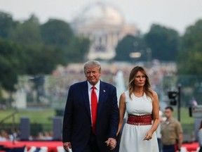 President Donald Trump and first lady Melania Trump walk back into the White House after hosting a "Salute to America" to celebrate the U.S. Independence Day holiday on the South Lawn of the White House in Washington July 4, 2020.