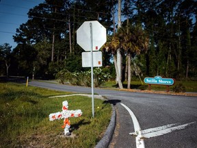 A white and orange cross with an "A" on it stands stuck in the ground along highway 17 at the entrance of the Satilla Shores neighbourhood where Ahmaud Arbery, an unarmed young black man, was shot after being chased by a white former law enforcement officer and his son, at the Glynn County Courthouse in Brunswick, Georgia, U.S., May 8, 2020.