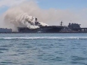 Smoke rises from a fire on board the U.S. Navy amphibious assault ship USS Bonhomme Richard at Naval Base San Diego, California, U.S., July 12, 2020 in this picture obtained from social media.