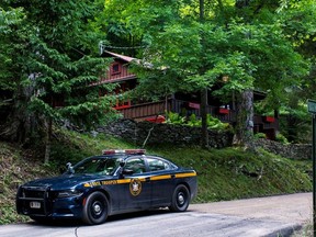 A New York State Trooper stands guard outside the home where attorney Roy Den Hollander was found dead after allegedly killing the son of federal judge Esther Salas and wounding her husband, in Catskills, New York, U.S. July 20, 2020. REUTERS/Eduardo Munoz ORG XMIT: PPP-EMZ114