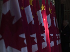 A Chinese flag is illuminated by sunshine in the Hall of Honour on Parliament Hill in Ottawa, Thursday, Sept. 22, 2016.