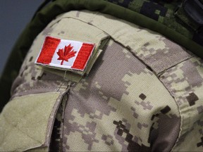 A Canadian flag patch is shown on a soldier's shoulder in Trenton, Ont., in an Oct. 16, 2014 file photo.