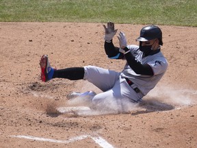 Isan Diaz of the Miami Marlins slides home safely to score a run in the top of the fourth inning against the Philadelphia Phillies at Citizens Bank Park on July 26, 2020 in Philadelphia, Pa.