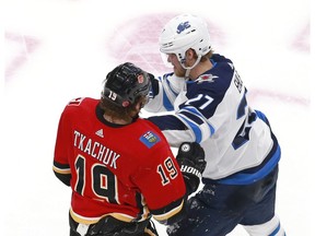 EDMONTON, ALBERTA - AUGUST 03: Nikolaj Ehlers #27 of the Winnipeg Jets shoves Matthew Tkachuk #19 of the Calgary Flames in the third period during Game Two of the Western Conference Qualification Round prior to the 2020 NHL Stanley Cup Playoffs at Rogers Place on August 03, 2020 in Edmonton, Alberta.