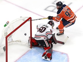 EDMONTON, ALBERTA - AUGUST 03: Connor McDavid #97 of the Edmonton Oilers scores his second goal against Corey Crawford #50 of the Chicago Blackhawks during the first period in Game Two of the Western Conference Qualification Round prior to the 2020 NHL Stanley Cup Playoffs at Rogers Place on August 03, 2020 in Edmonton, Alberta.