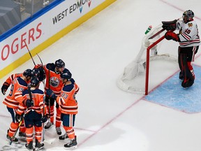 Edmonton Oilers players celebrate forward Alex Chiasson's third-period goal on Chicago Blackhawks goalie Corey Crawford on Aug. 3, 2020, during Game 2 of their Stanley Cup Playoffs qualifying series.