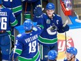 Bo Horvat and Jake Virtanen celebrate a 4-3 victory Tuesday.