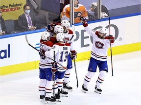 Jesperi Kotkaniemi #15 of the Montreal Canadiens celebrates with his teammates after scoring a goal on Brian Elliott of the Philadelphia Flyers during the third period in Game Two of the Eastern Conference First Round in the 2020 NHL Stanley Cup Playoffs at Scotiabank Arena on August 14, 2020 in Toronto.