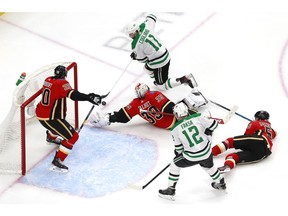 Andrew Cogliano (No. 11) of the Dallas Stars takes a shot on goaltender Cam Talbot of the Calgary Flames in overtime during Game 4 of the Western Conference quarterfinal during the 2020 NHL Stanley Cup Playoffs at Rogers Place on August 16, 2020, in Edmonton.