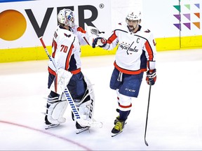 Alex Ovechkin, right, of the Washington Capitals is congratulated by his teammate, Braden Holtby after scoring a goal at 3:40 against the New York Islanders during the third period in Game 4 of the Eastern Conference First Round during the 2020 NHL Stanley Cup Playoffs at Scotiabank Arena on Aug. 18, 2020 in Toronto.