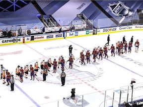 Players from the Montreal Canadiens and Philadelphia Flyers shake hands after Game 6 of their first round NHL playoff series Friday night at Scotiabank Arena in Toronto. The Flyers won the game 3-2 to win the best-of-seven series 4-2.