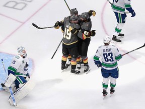Reilly Smith #19 of the Vegas Golden Knights scores on the power play at 2:13 of the second period and celebrates Alex Tuch #89 and Alec Martinez #23.