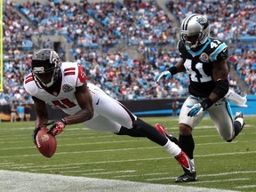 Captain Munnerlyn of the Carolina Panthers watches as Julio Jones of the Atlanta Falcons drops a pass during their game at Bank of America Stadium on December 9, 2012 in Charlotte, North Carolina.