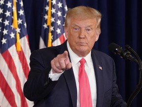 U.S. President Donald Trump gestures after signing executive orders for economic relief during a news conference amid the spread of the coronavirus disease, at his golf resort in Bedminster, N.J., Aug. 8, 2020.