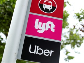 A sign marks a rendezvous location for Lyft and Uber users at San Diego State University in San Diego, Calif., May 13, 2020.