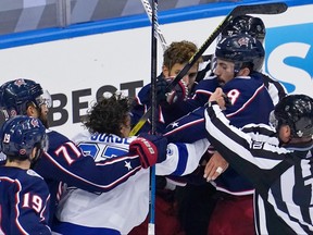 Columbus Blue Jackets defenceman Zach Werenski (8) and Tampa Bay Lightning centre Yanni Gourde (37) are separated by other players and officials during the second period of game three of the first round of the 2020 Stanley Cup Playoffs at Scotiabank Arena in Toronto, Aug. 15, 2020.