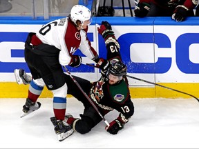 Colorado Avalanche defenseman Nikita Zadorov, left, checks Arizona Coyotes right wing Vinnie Hinostroza during the second period in game four of the first round of the 2020 Stanley Cup Playoffs at Rogers Place in Edmonton, Aug. 17, 2020.