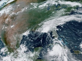 Tropical Storm Marco arrives at the coast of Louisiana as Tropical Storm Laura follows (bottom right) in an image from the National Oceanic and Atmospheric Administration (NOAA) GOES-East satellite Aug. 24, 2020.