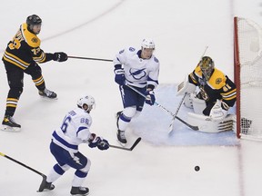 Boston Bruins goaltender Jaroslav Halak, right, defends the net against Tampa Bay Lightning right wing Nikita Kucherov, bottom left, and left wing Ondrej Palat, second from right, during the third period in Game 4 of the second round of the 2020 Stanley Cup Playoffs at Scotiabank Arena in Toronto, Aug. 29, 2020.