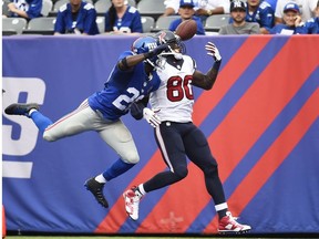 Prince Amukamara of the New York Giants breaks up a pass against  Andre Johnson of the Houston Texans at MetLife Stadium on September 21, 2014 in East Rutherford, New Jersey.