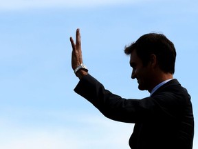 Swiss tennis champion Roger Federer is seen in silhouette taking part in the ceremony marking the inauguration of a street bearing his name on April 21, 2016 in Biel.