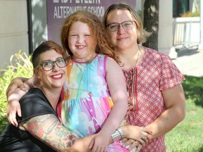 Ariel Troster and her wife, Caitlyn Pascal, right, with their daughter, Daphne Pascal-Troster outside of Daphne's school in Ottawa Friday.