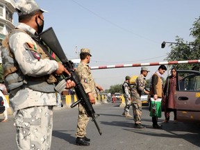 Afghan policemen stand guard at a check point in Kabul, Afghanistan August 7, 2020.